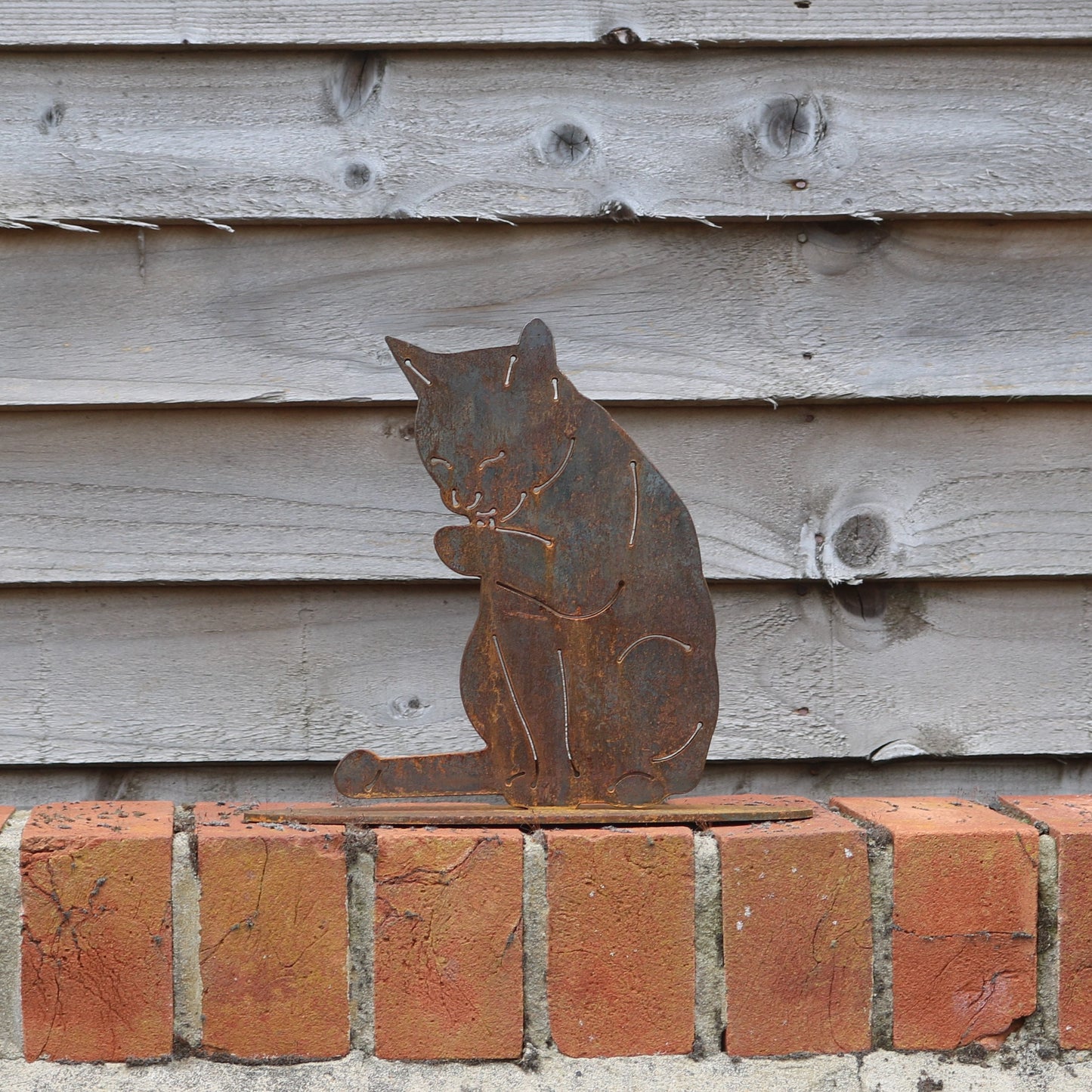 Cat Licking Its Paw Statue