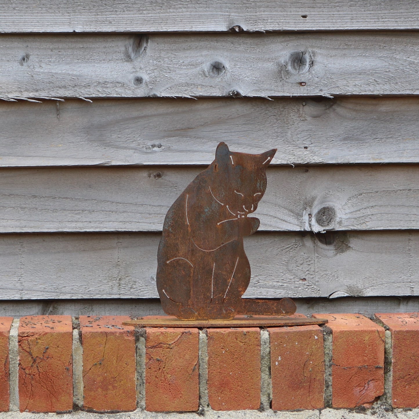 Cat Licking Its Paw Statue
